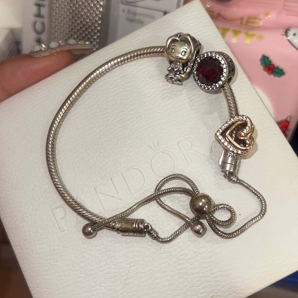 Pandora charm bracelet adjustable with three charms barely worn with box